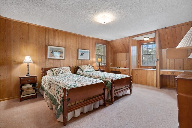 carpeted bedroom with wood walls and a textured ceiling