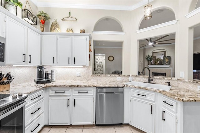 kitchen with white cabinets, appliances with stainless steel finishes, and sink