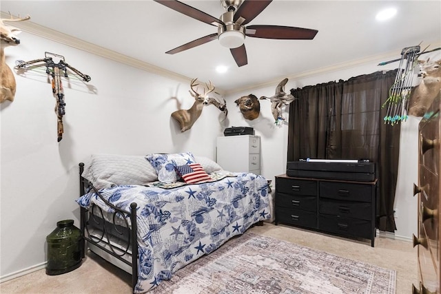 carpeted bedroom featuring ceiling fan and ornamental molding