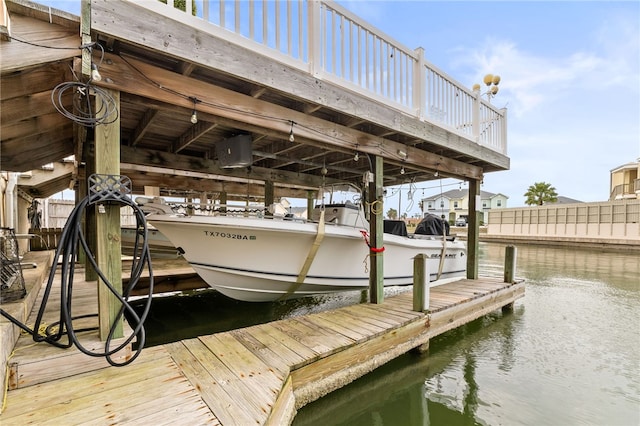 dock area with a water view and boat lift