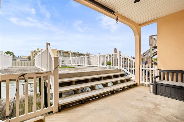 wooden deck featuring fence and stairs