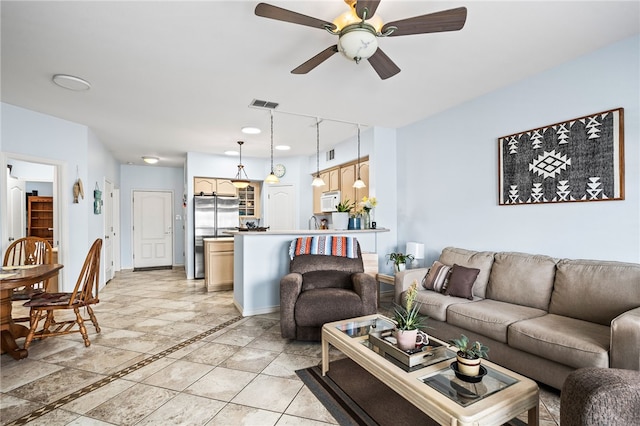 living room featuring baseboards, visible vents, and a ceiling fan