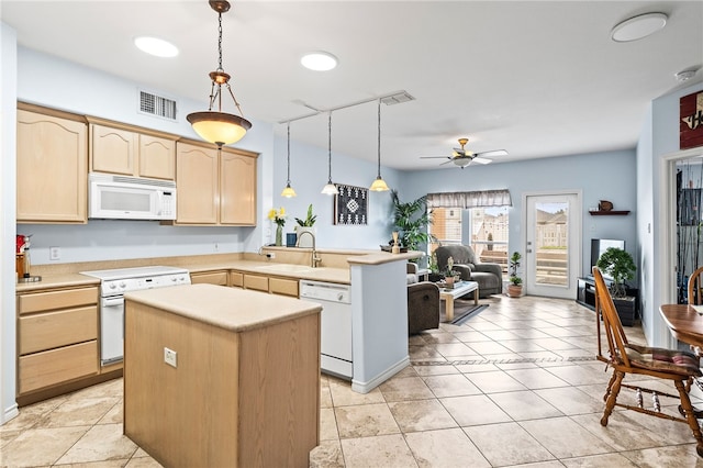 kitchen with light brown cabinetry, white appliances, a sink, and visible vents