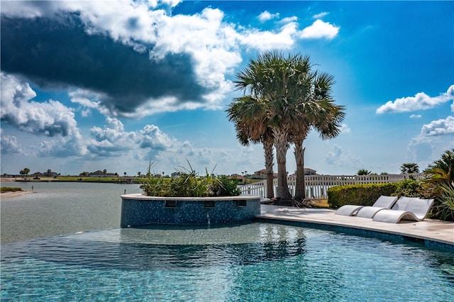 view of pool featuring a water view