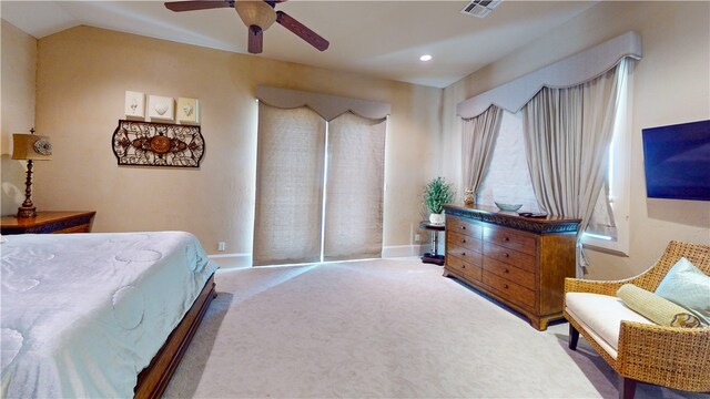 carpeted bedroom featuring lofted ceiling and ceiling fan