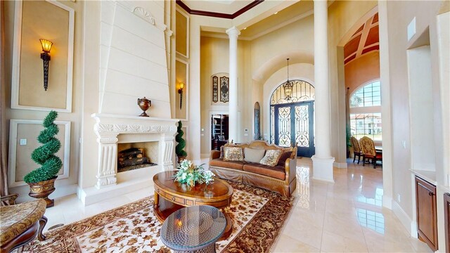 153 E Tuscany Way, Port Oconnor, TX 77982 - living room featuring ornate columns, crown molding, a high ceiling, and baseboards