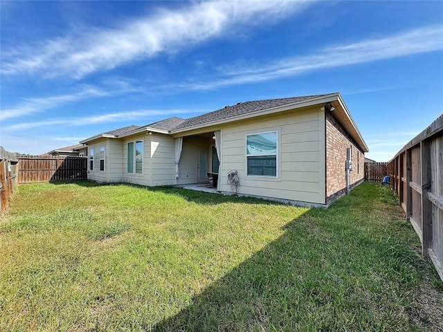 back of house with a lawn