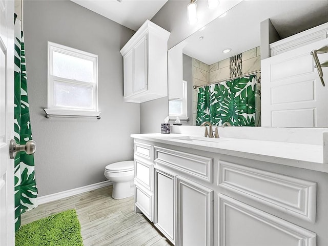 bathroom with a shower with curtain, vanity, and toilet