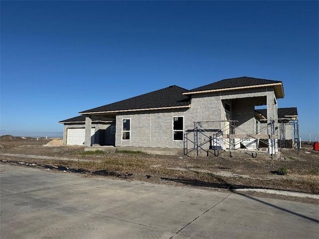 rear view of property featuring a garage