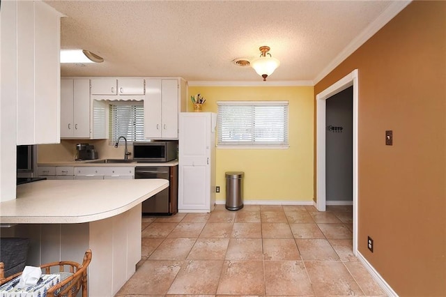 kitchen with white cabinets, sink, a textured ceiling, appliances with stainless steel finishes, and kitchen peninsula