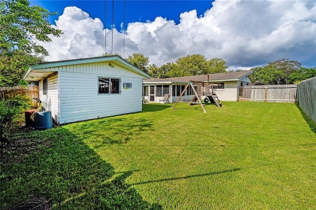 rear view of property with a yard and a sunroom