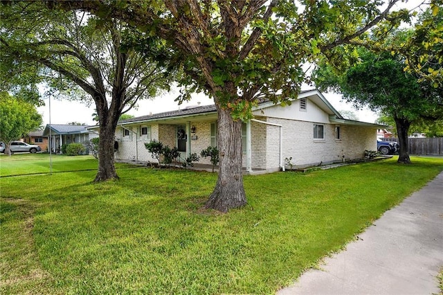 ranch-style home featuring a front yard