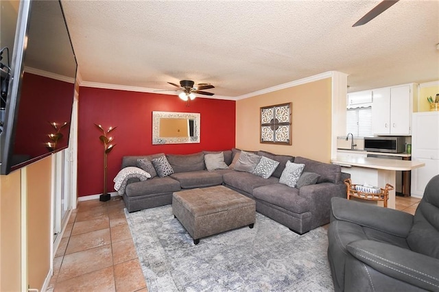 living room featuring light tile patterned floors, a textured ceiling, crown molding, and sink