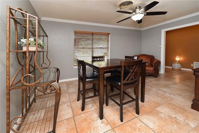 dining area featuring ceiling fan, a textured ceiling, and ornamental molding