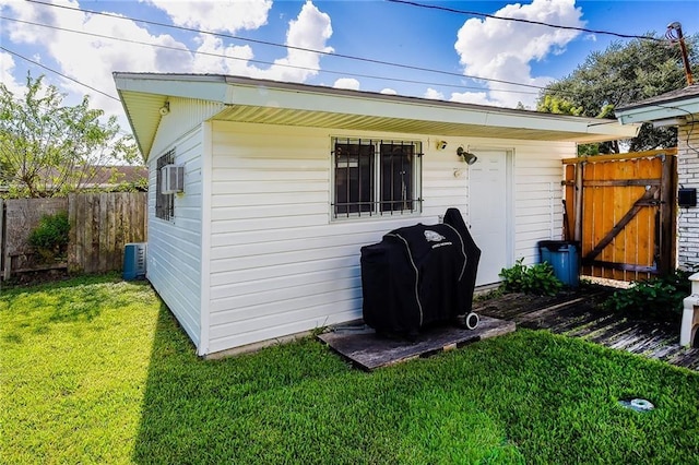 exterior space with central air condition unit and a yard