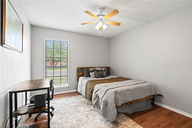 3029 White Bird Dr, Corpus Christi, TX 78415 - bedroom with wood finished floors, a textured ceiling, ceiling fan, and baseboards