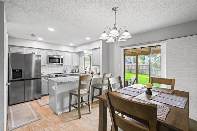 3029 White Bird Dr, Corpus Christi, TX 78415 - dining room with a textured ceiling, a chandelier, and recessed lighting