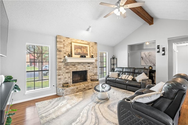3029 White Bird Dr, Corpus Christi, TX 78415 - living room with wood finished floors, ceiling fan, healthy amount of natural light, a brick fireplace, and a textured ceiling