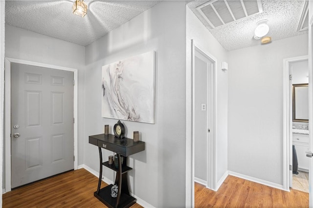 3029 White Bird Dr, Corpus Christi, TX 78415 - entrance foyer featuring a textured ceiling, wood finished floors, and baseboards