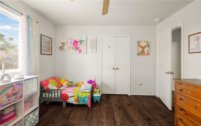 bedroom with ceiling fan, dark hardwood / wood-style flooring, and a closet