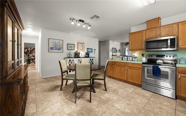 kitchen with light tile patterned floors and appliances with stainless steel finishes