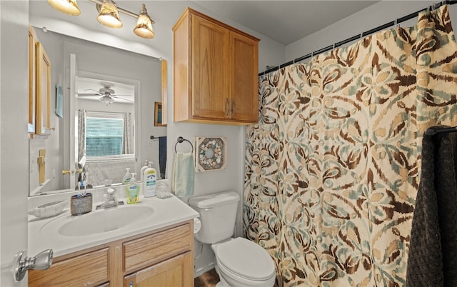 bathroom featuring ceiling fan, vanity, a shower with curtain, and toilet