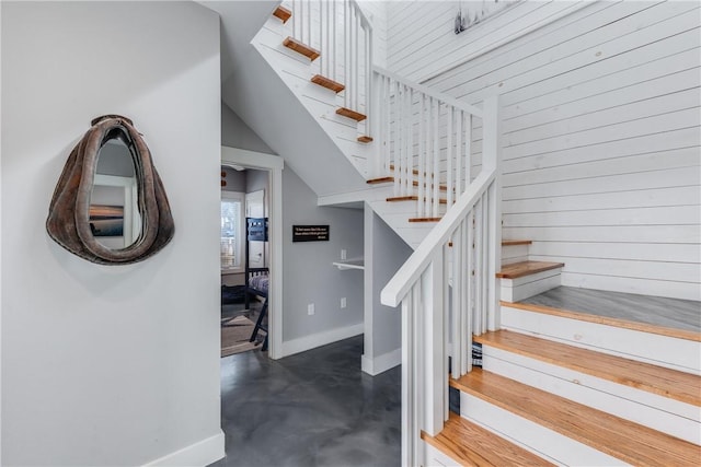 stairs with wooden walls and concrete floors