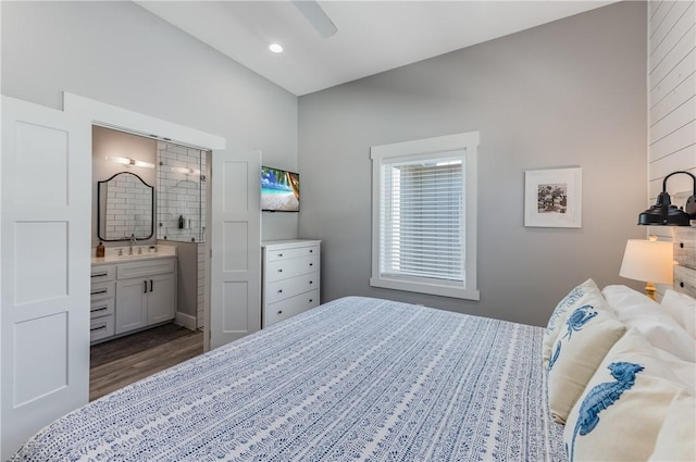 bedroom with ceiling fan, connected bathroom, dark hardwood / wood-style floors, and sink