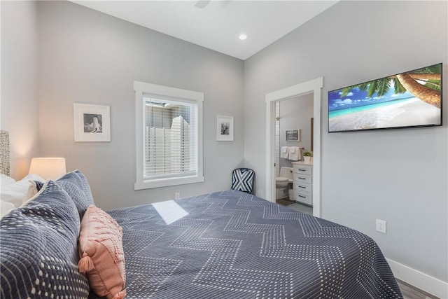 bedroom featuring ensuite bathroom and wood-type flooring