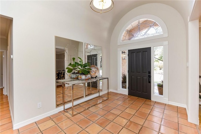 tiled foyer with a high ceiling