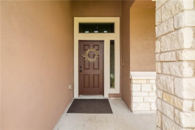 6930 Anastasia, Corpus Christi, TX 78413 - doorway to property featuring stucco siding and stone siding