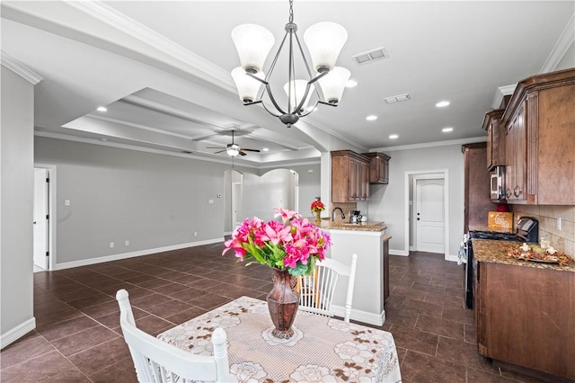 6930 Anastasia, Corpus Christi, TX 78413 - dining room featuring a chandelier, a ceiling fan, recessed lighting, crown molding, and dark tile patterned floors