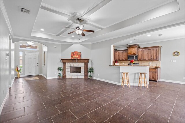 6930 Anastasia, Corpus Christi, TX 78413 - unfurnished living room with ceiling fan, recessed lighting, baseboards, dark tile patterned floors, and crown molding