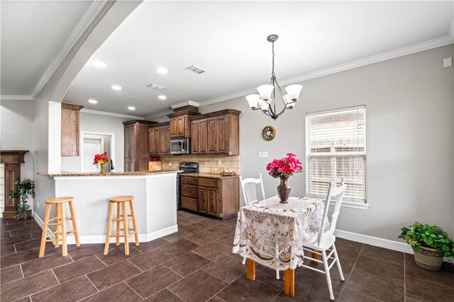 6930 Anastasia, Corpus Christi, TX 78413 - kitchen with stainless steel microwave, a chandelier, recessed lighting, a kitchen bar, and baseboards