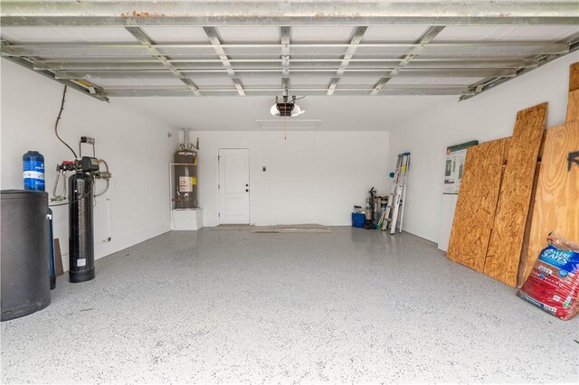 6930 Anastasia, Corpus Christi, TX 78413 - garage with secured water heater and a garage door opener