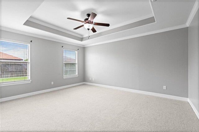 6930 Anastasia, Corpus Christi, TX 78413 - empty room with a tray ceiling, ornamental molding, light colored carpet, a ceiling fan, and baseboards