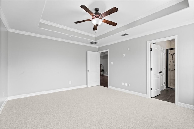 6930 Anastasia, Corpus Christi, TX 78413 - unfurnished bedroom featuring a tray ceiling, dark colored carpet, baseboards, ornamental molding, and ceiling fan