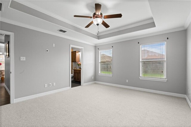 6930 Anastasia, Corpus Christi, TX 78413 - unfurnished bedroom featuring a raised ceiling, carpet flooring, crown molding, baseboards, and ensuite bathroom