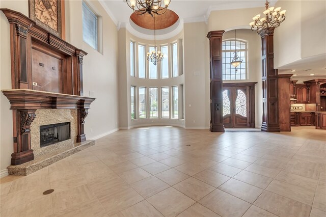 6522 Miranda Dr, Corpus Christi, TX 78414 - foyer featuring a chandelier, a towering ceiling, crown molding, baseboards, and light tile patterned flooring