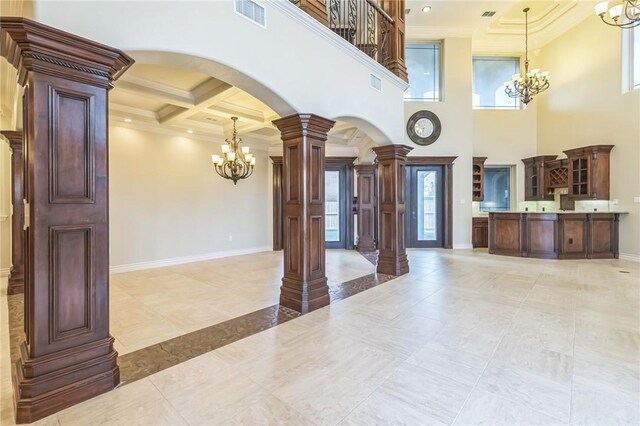 6522 Miranda Dr, Corpus Christi, TX 78414 - entryway with a chandelier, arched walkways, ornate columns, crown molding, and coffered ceiling
