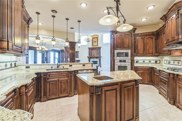 6522 Miranda Dr, Corpus Christi, TX 78414 - kitchen with appliances with stainless steel finishes, a sink, backsplash, a peninsula, and decorative light fixtures