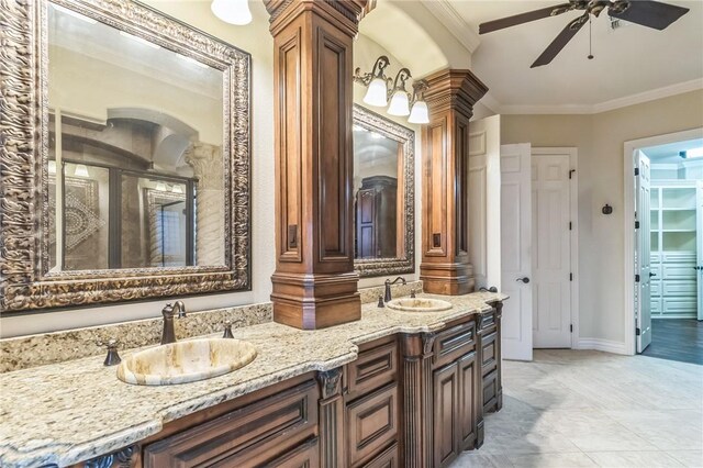 6522 Miranda Dr, Corpus Christi, TX 78414 - full bath with double vanity, ceiling fan, crown molding, ornate columns, and baseboards