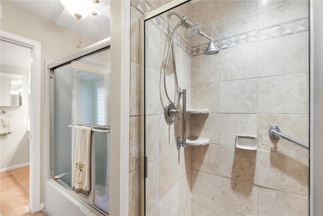 bathroom featuring combined bath / shower with glass door