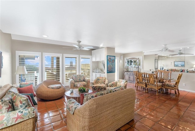 living room featuring tile patterned floors and ceiling fan