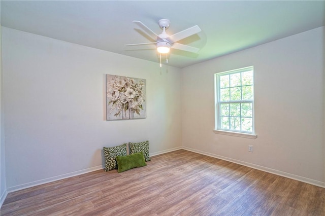 2322 Violet, Corpus Christi, TX 78410 - spare room featuring wood finished floors, ceiling fan, and baseboards