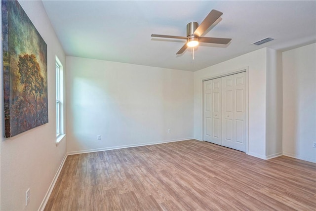 2322 Violet, Corpus Christi, TX 78410 - unfurnished bedroom with light wood-style floors, baseboards, a closet, and a ceiling fan