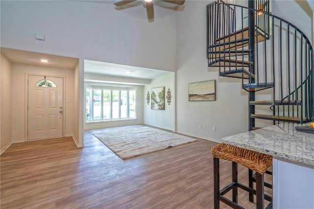 2322 Violet, Corpus Christi, TX 78410 - foyer entrance featuring baseboards, wood finished floors, a towering ceiling, stairway, and a ceiling fan
