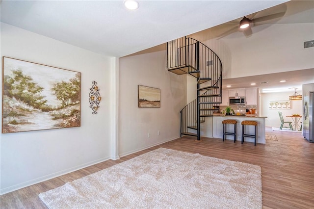 2322 Violet, Corpus Christi, TX 78410 - unfurnished living room with light wood-style flooring, stairs, a ceiling fan, baseboards, and recessed lighting