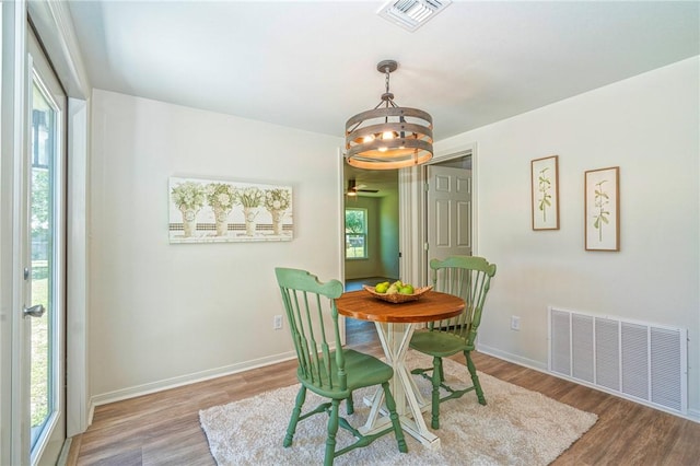 2322 Violet, Corpus Christi, TX 78410 - dining room with a chandelier, wood finished floors, baseboards, and ceiling fan