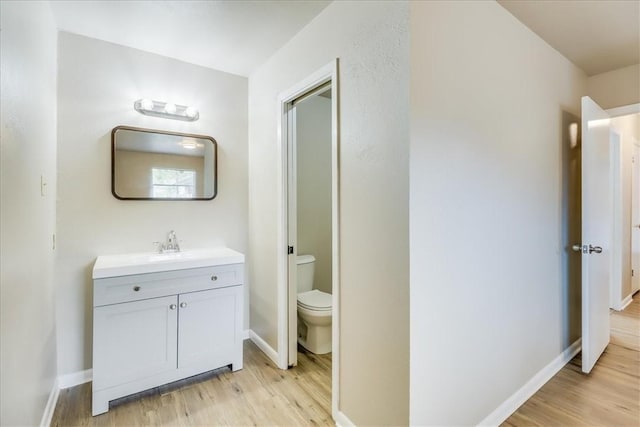 4113 Sierra St, Corpus Christi, TX 78410 - bathroom featuring wood finished floors, vanity, toilet, and baseboards